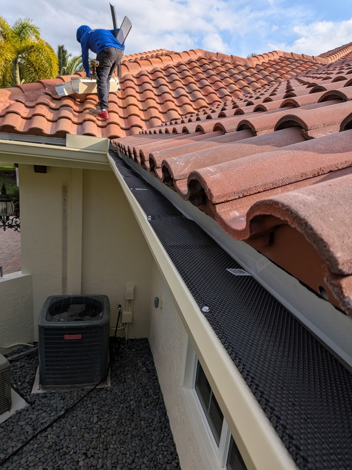 Installing a gutter leaf guard on a tile roof