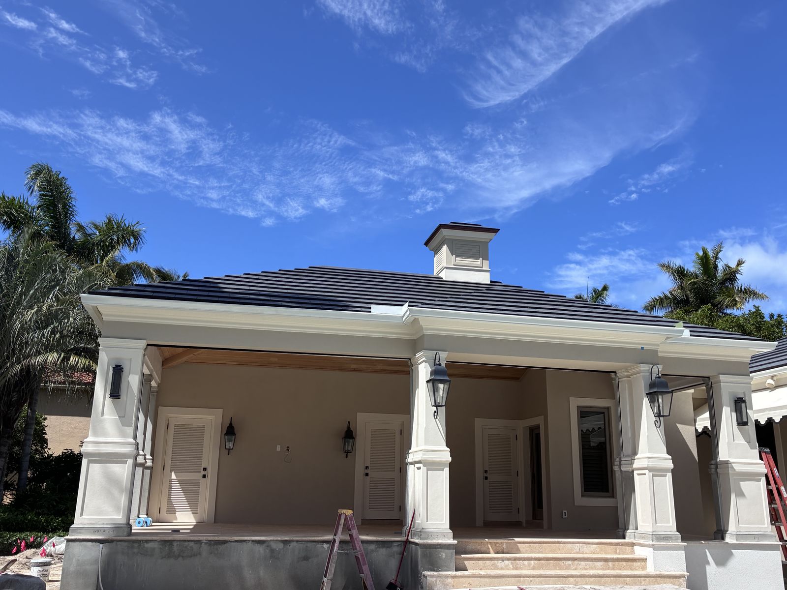 Seamless gutters and downspout on a South Florida home with a covered porch