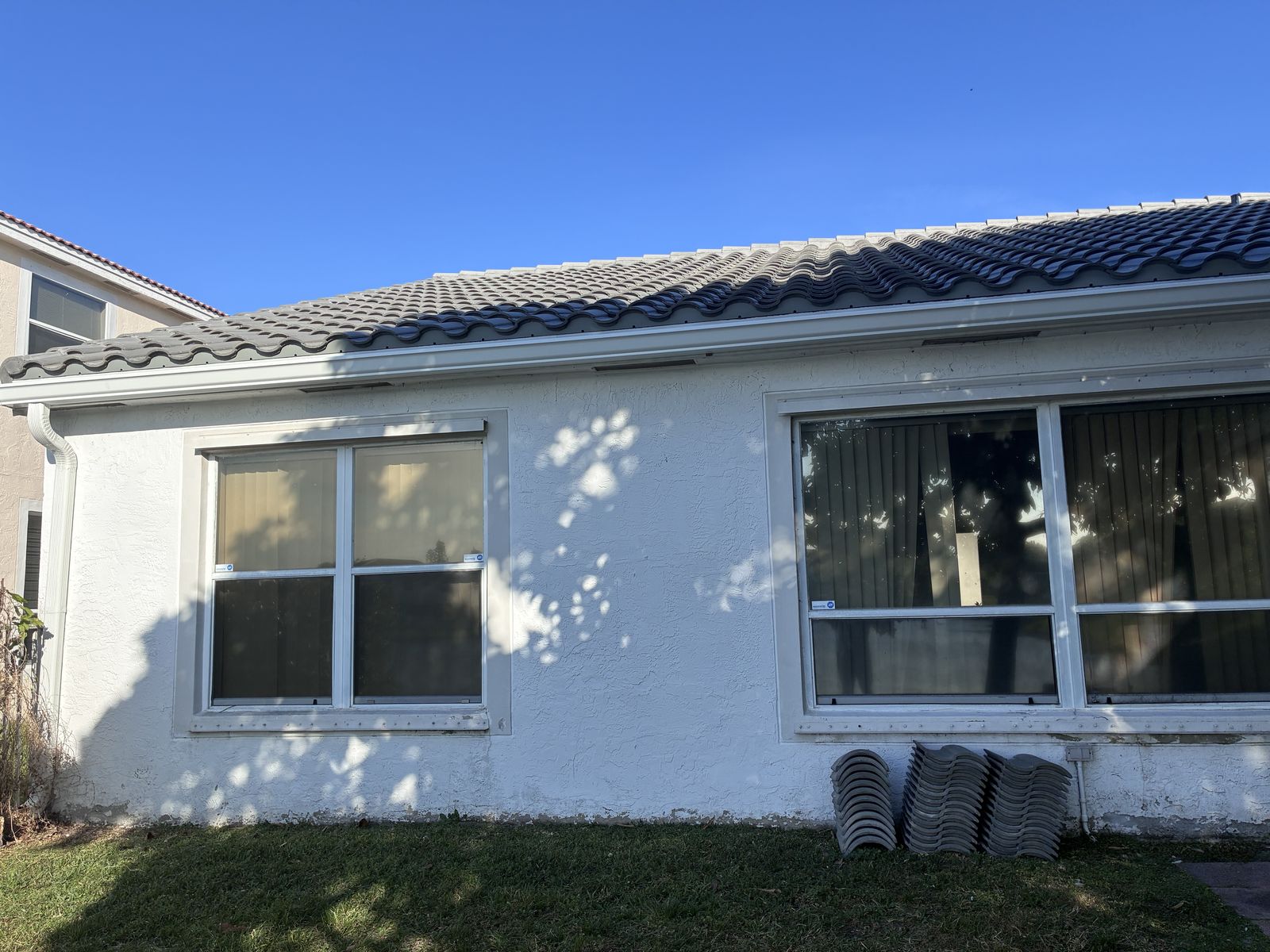 Seamless gutters and downspout on a tile-roof home