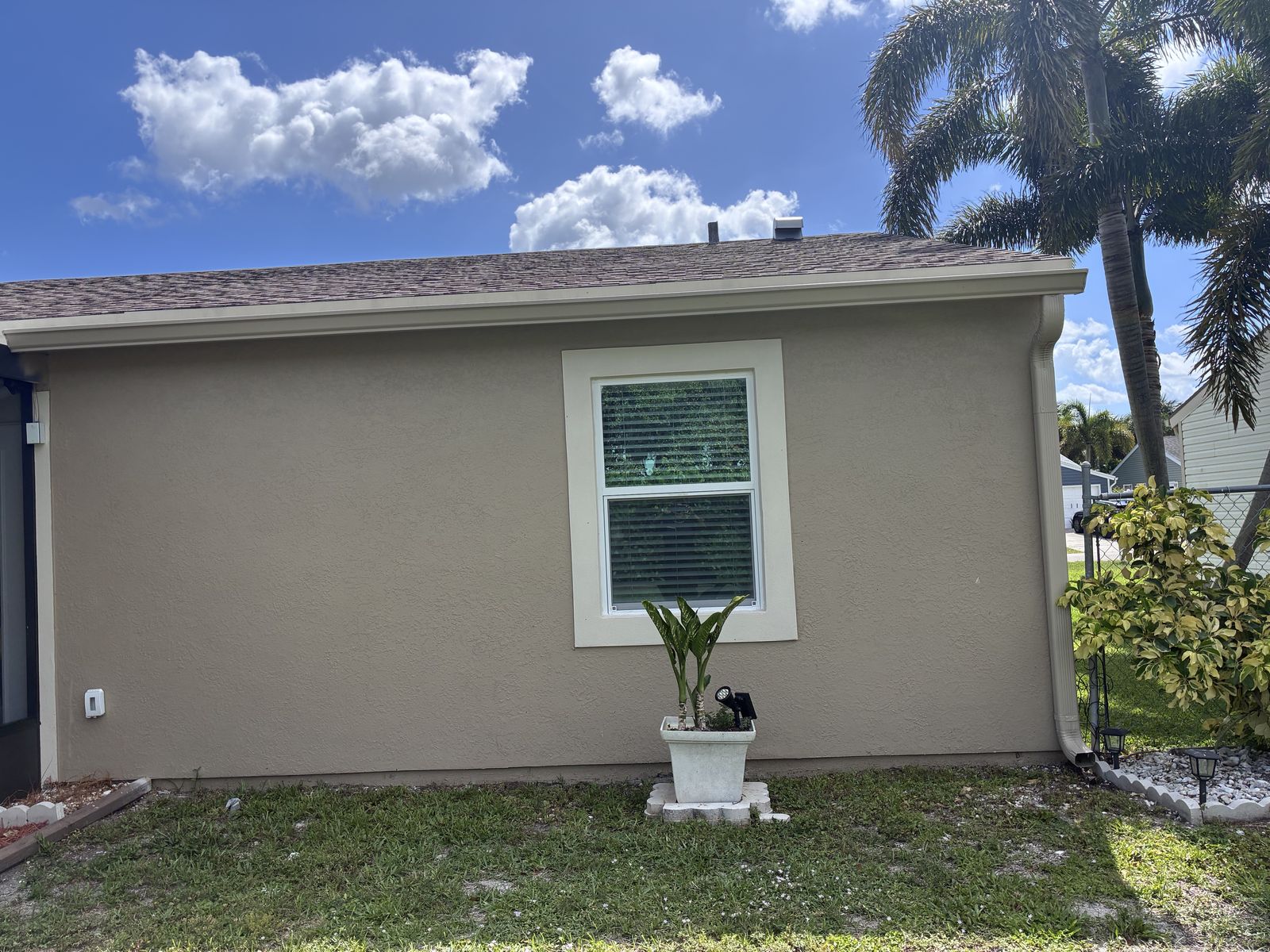 Seamless gutter and white downspout on a single-story home