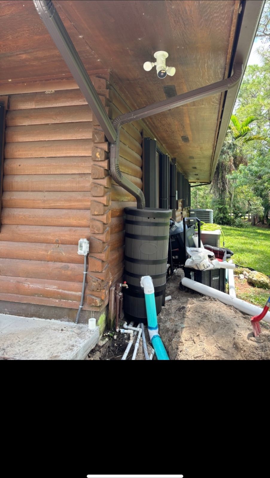 Seamless gutter and downspout directed to a rain barrel