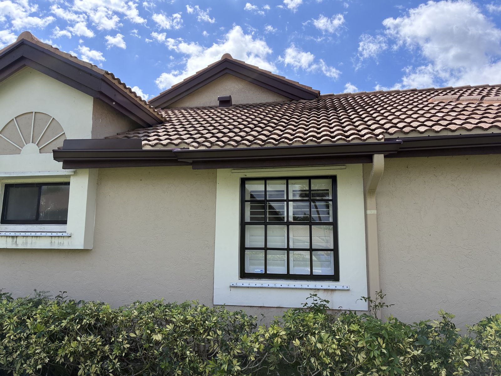 Brown seamless gutter on a tile-roof home