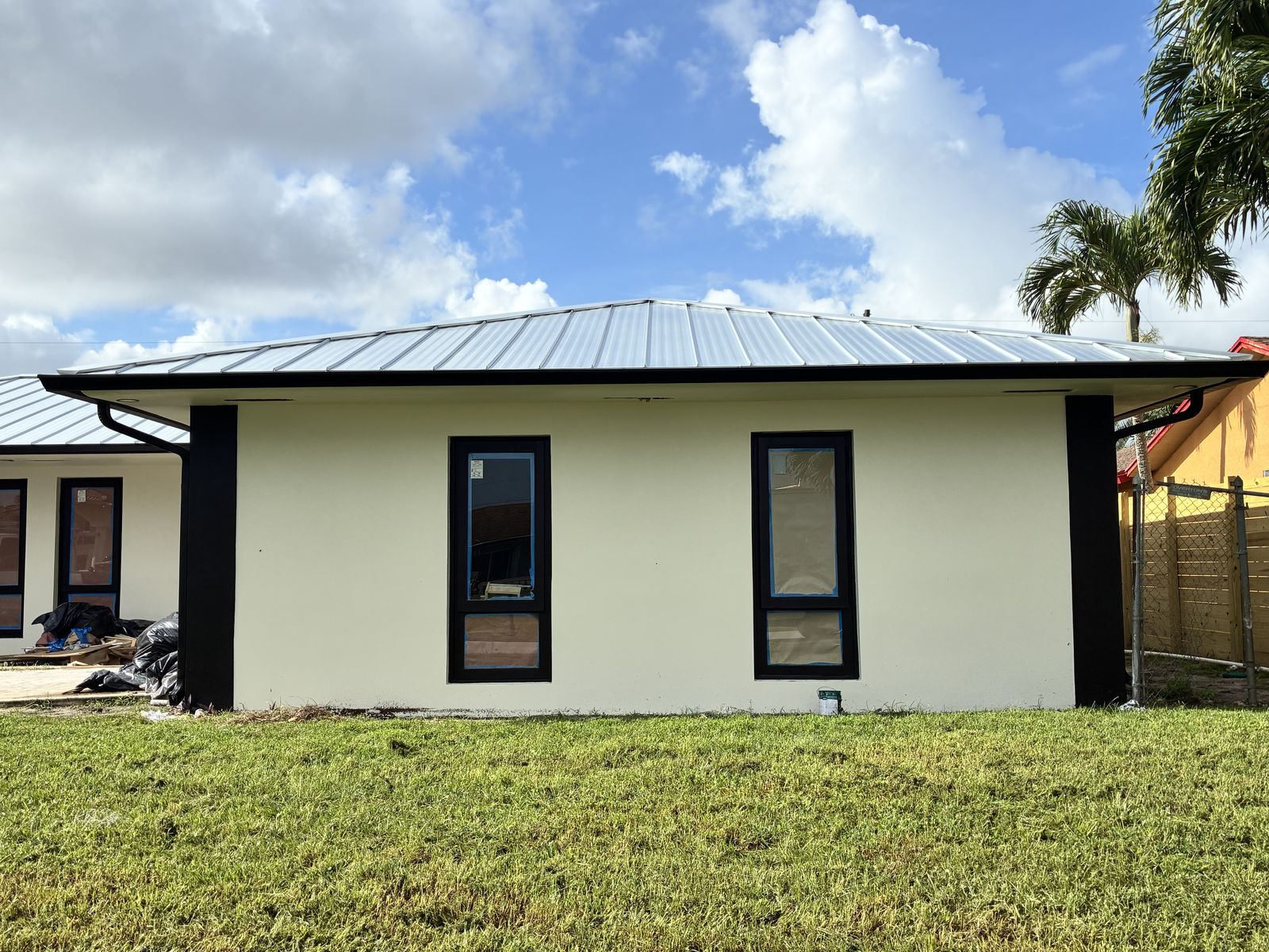 Black seamless gutter on a standing-seam metal-roof home