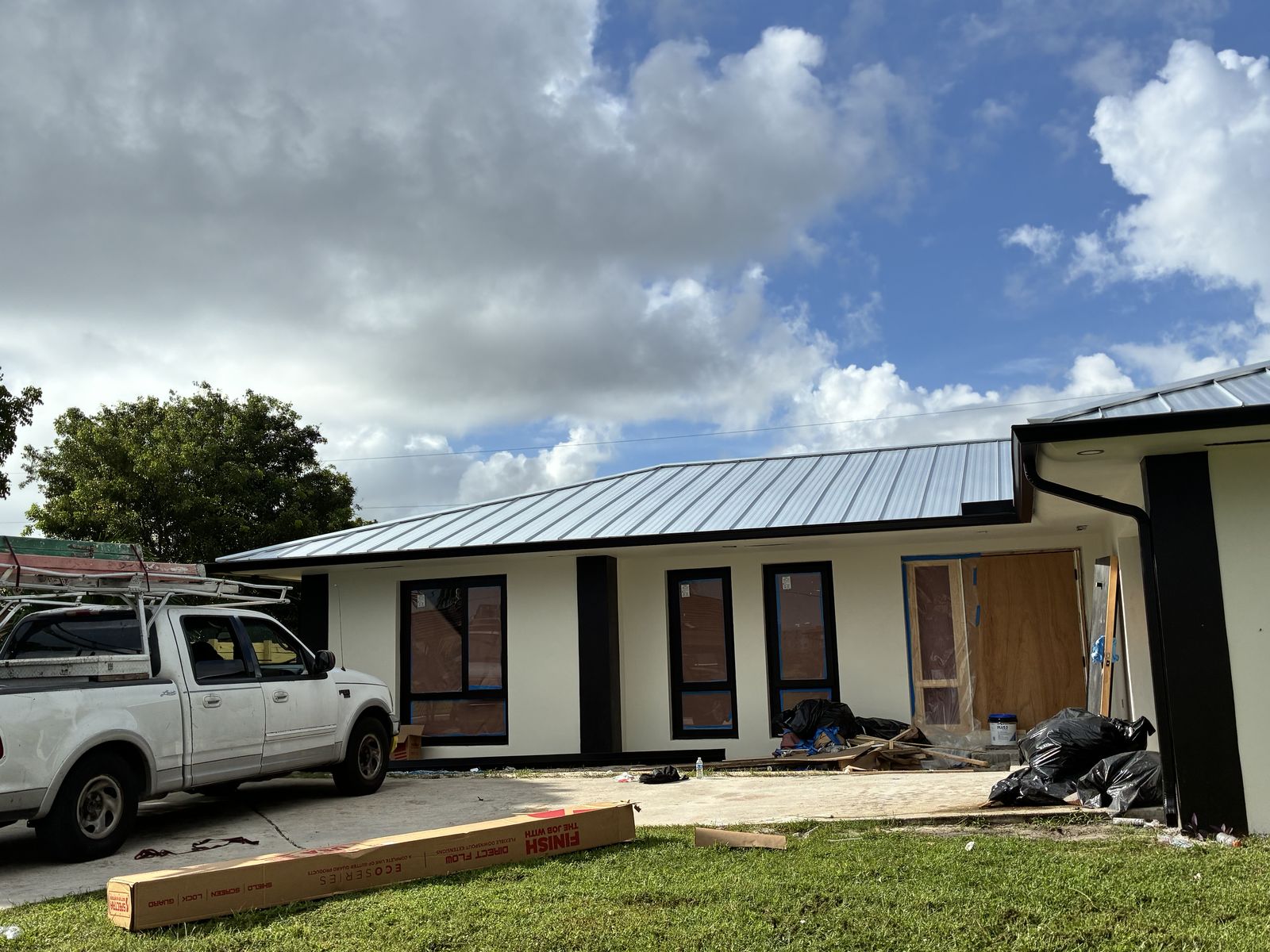 Seamless gutter and downspout on a metal-roof home