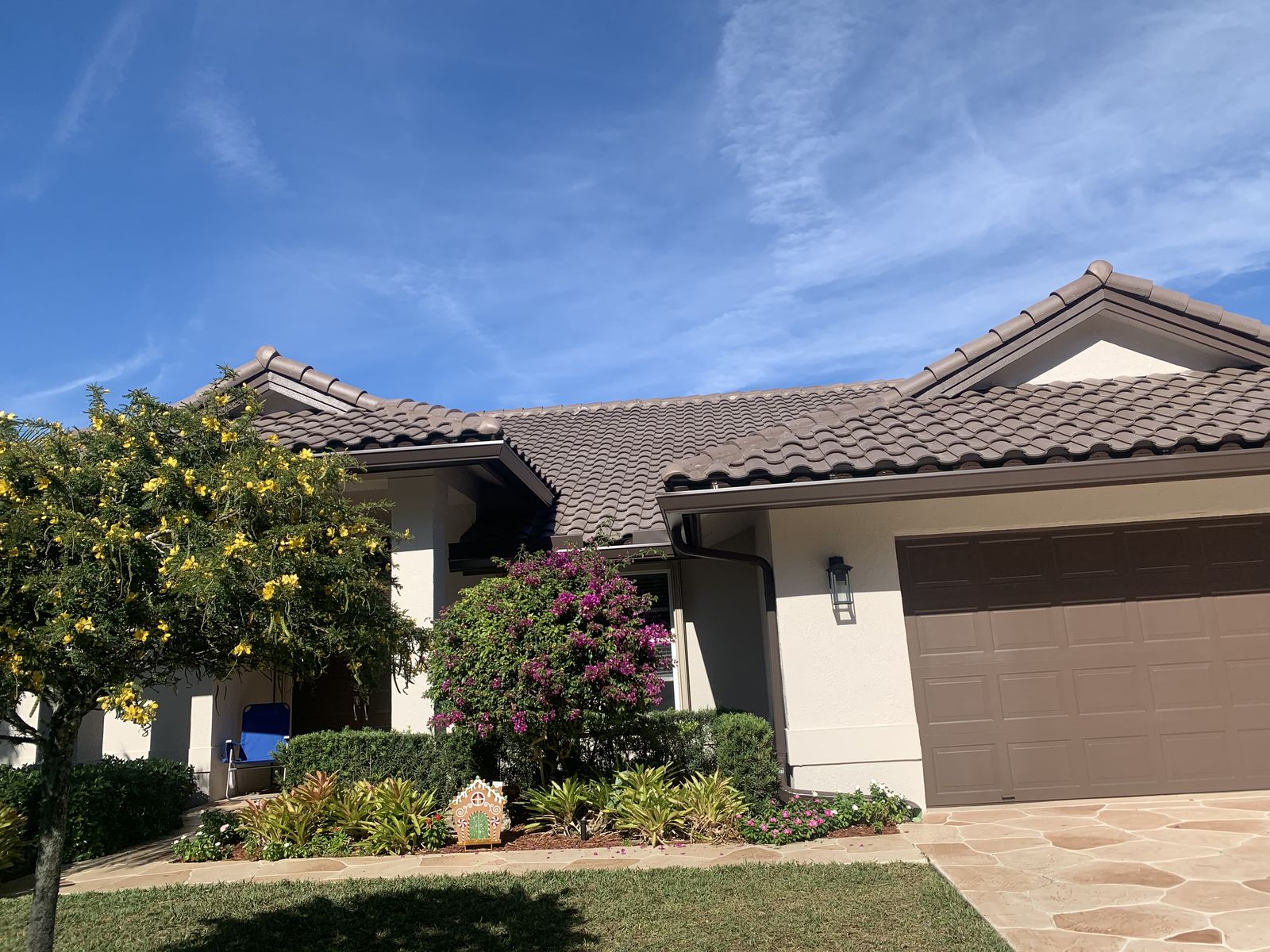Seamless gutters matched to the trim of a landscaped South Florida home