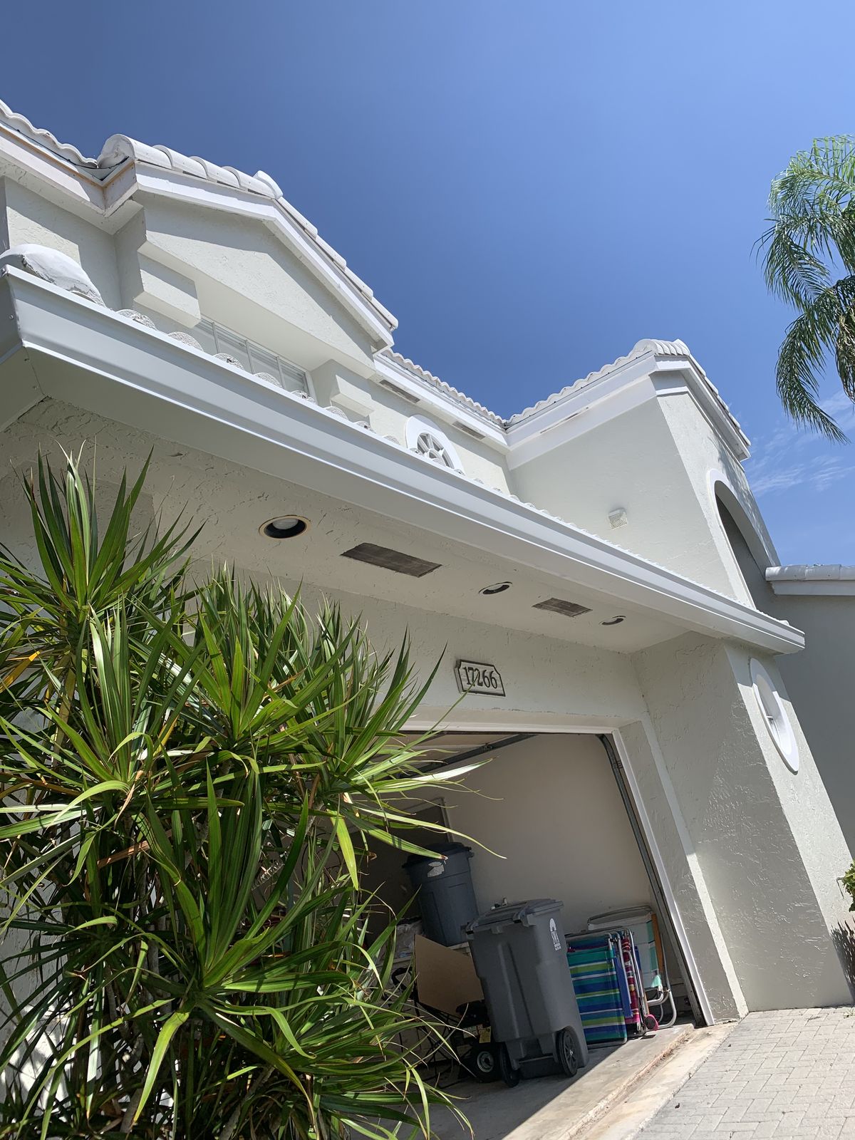 Seamless gutters along the roofline of a two-story South Florida home