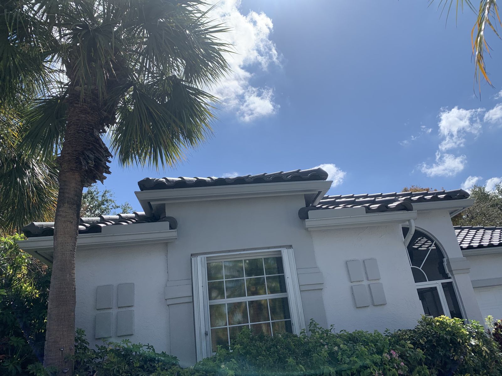 Seamless gutter along the roofline of a tile-roof South Florida home