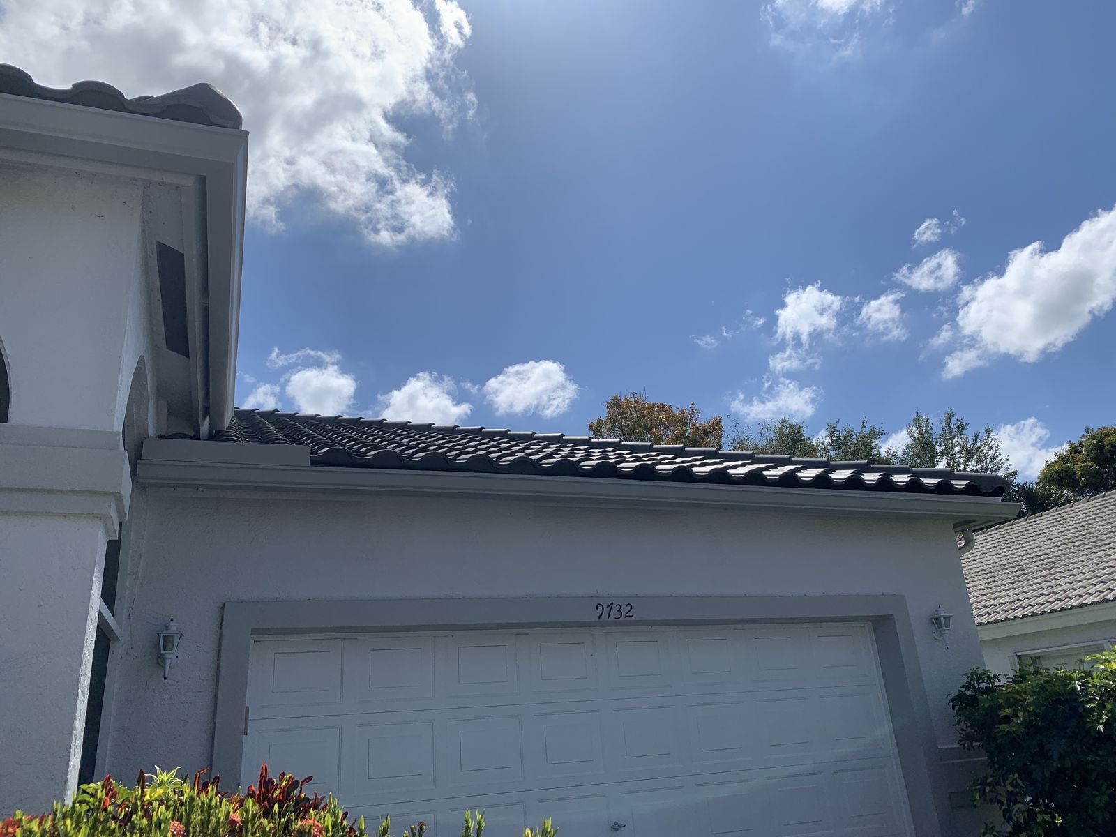 White seamless gutter and downspout on a tile-roof South Florida home
