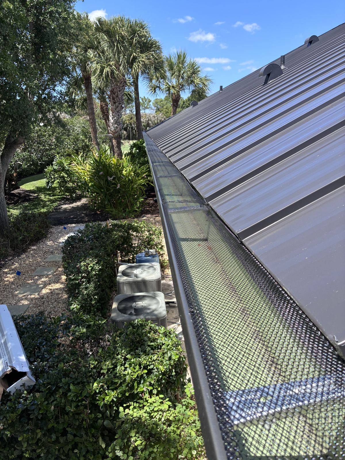 Leaf guard / gutter screen installed over a gutter