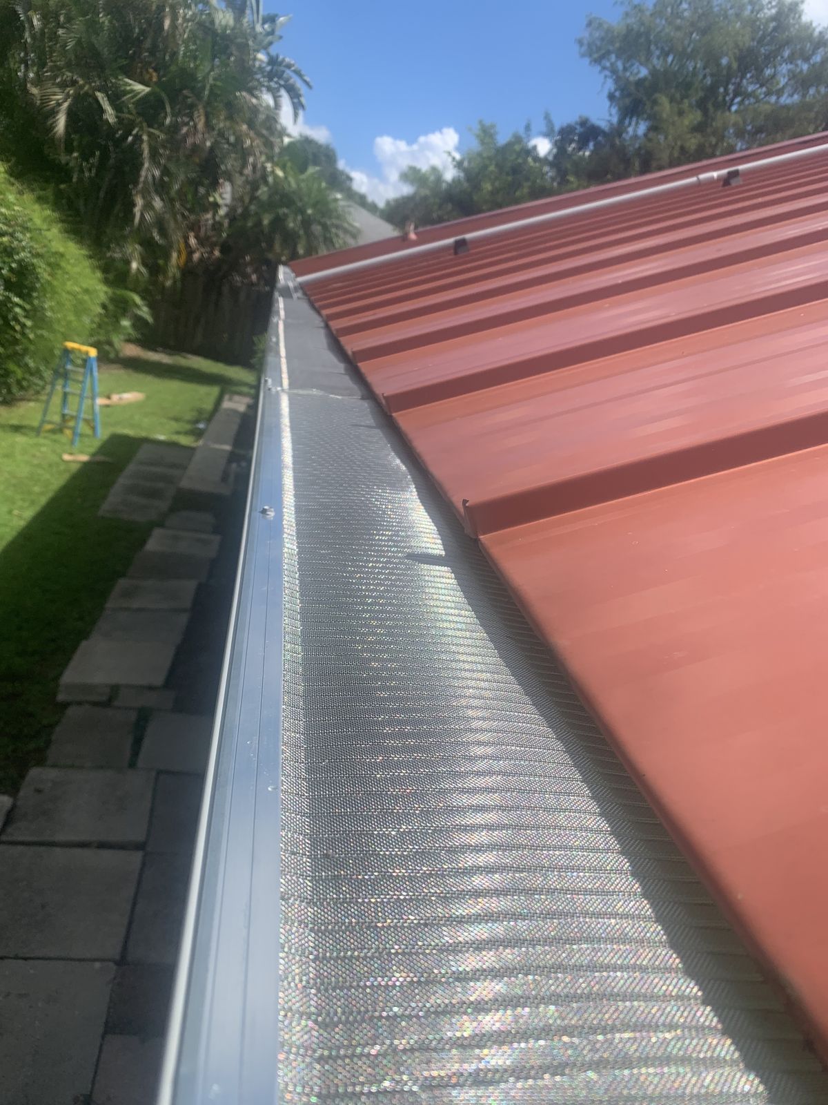 Leaf guard / gutter screen on a metal-roof home