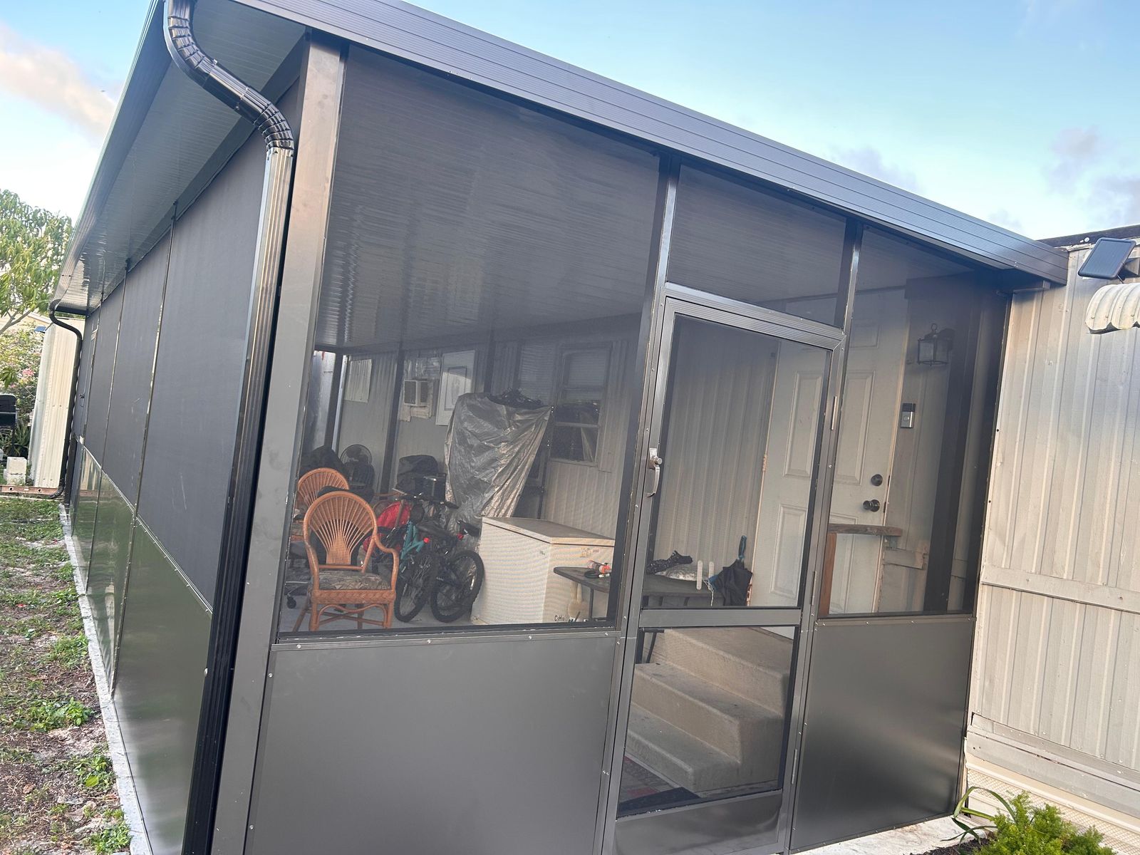 Screen enclosure with a screen door on a patio